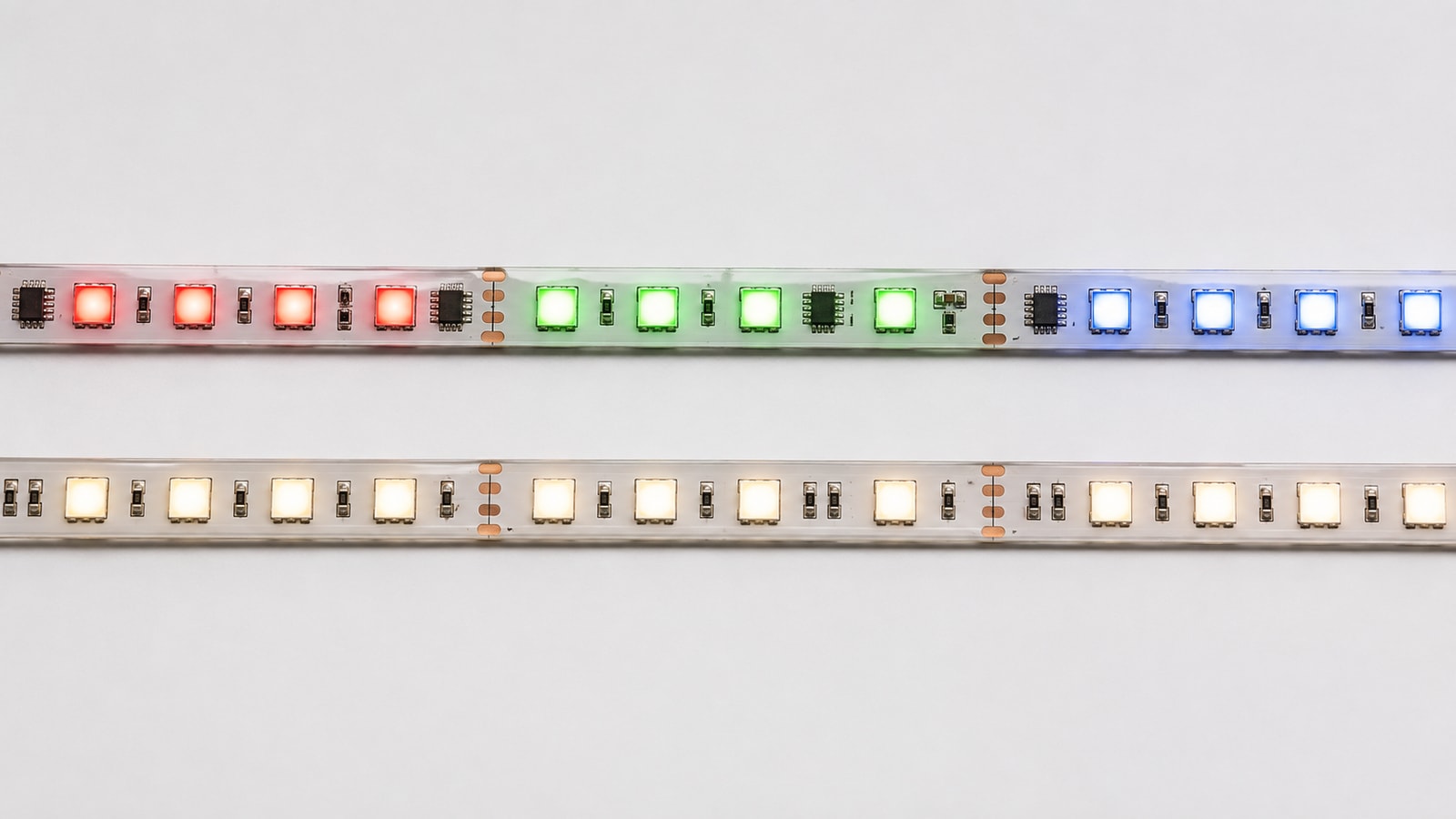 Two LED strips comparing addressable RGBIC color zones with uniform warm-white RGBW output