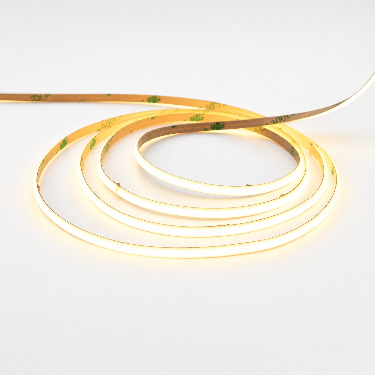 Illuminated low-voltage COB LED strip arranged in a coil